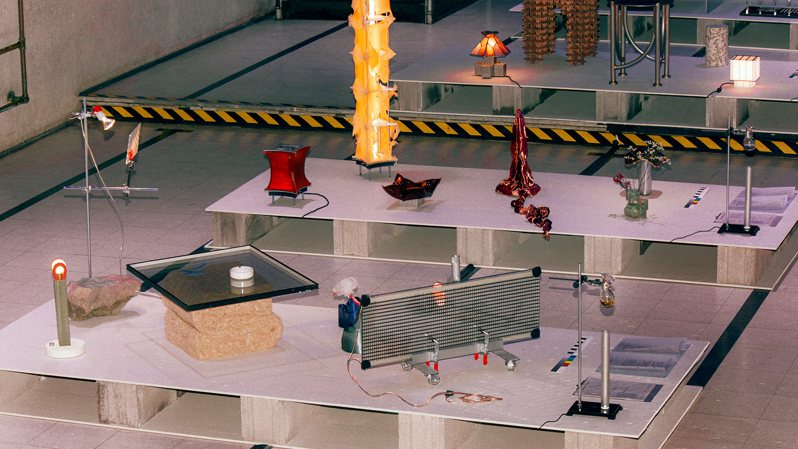 An exhibition of various experimental designs arranged on raised platforms.